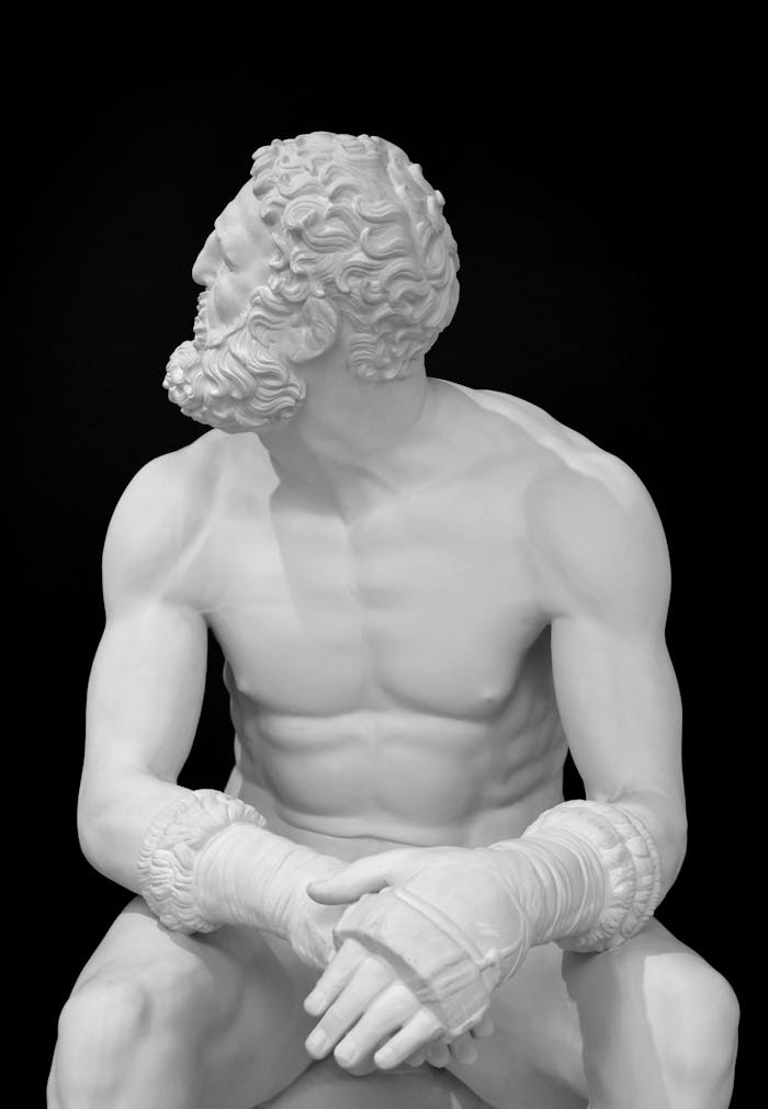 Elegant Greek statue with a sophisticated black backdrop creating a dramatic effect.